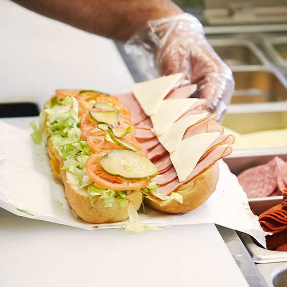 Sub sandwich being prepared